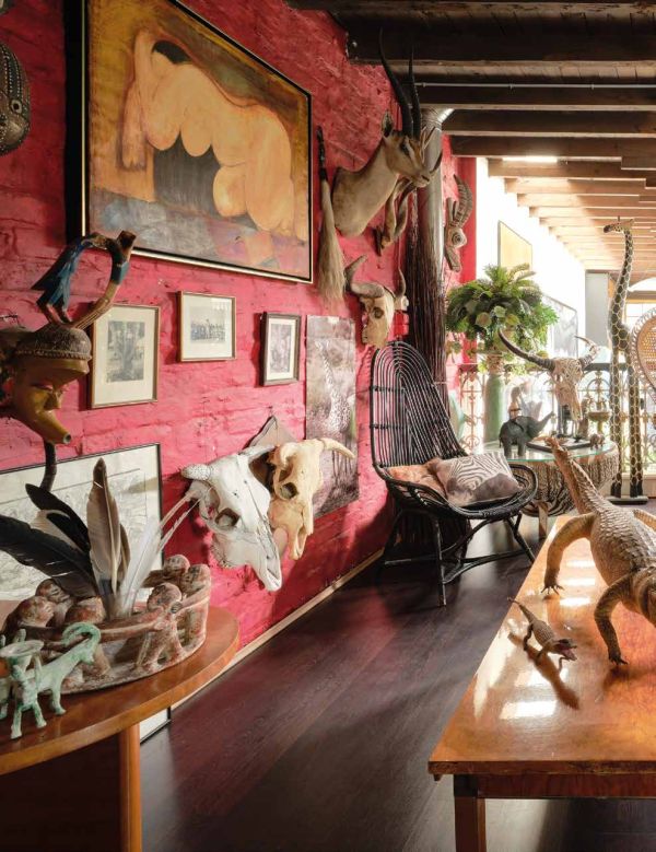 Book cover of Knokke Le Zoute Interiors, Living by the Sea, with white, open-plan kitchen/living room interior with wood floors. Published by Lannoo Publishers.