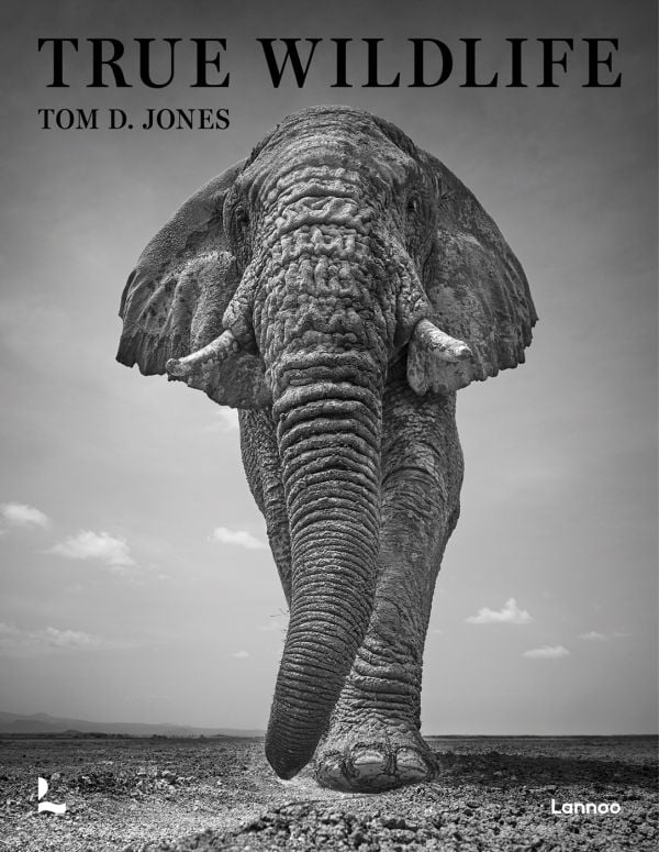 Book cover of True Wildlife, with African bush elephant walking towards camera. Published by Lannoo Publishers.