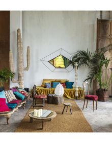 Book cover of Homes Decorated by Nature, with an interior living room with soft cream leather chair, large mirror and houseplants. Published by Lannoo Publishers.