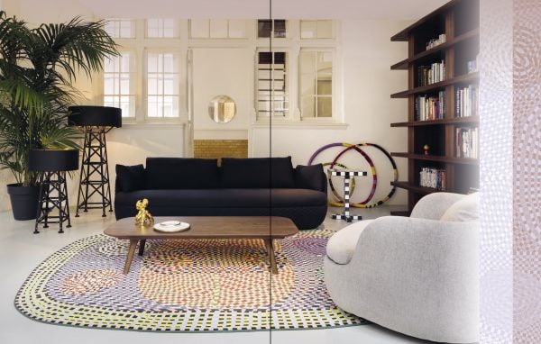 Book cover of Decorate Your Home With Carpets and Rugs, with an interior living space blush velvet scallop chair, houseplants and gold drinks trolley. Published by Lannoo Publishers.