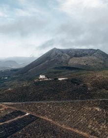 Book cover of Canary Islands: A Visual Travel Guide Through the Canarias, with a mountainous landscape. Published by Lannoo Publishers.