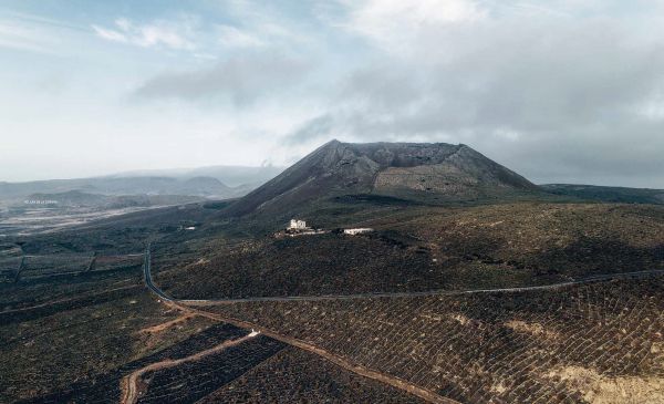 Book cover of Canary Islands: A Visual Travel Guide Through the Canarias, with a mountainous landscape. Published by Lannoo Publishers.