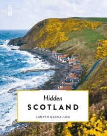 Aberdeenshire coastline with yellow gorse, houses near sea, on cover of 'Hidden Scotland', by Luster Publishing.