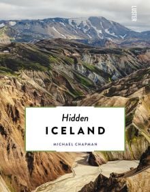 Book cover of Hidden Iceland, with an aerial view of mountainous landscape. Published by Luster Publishing.