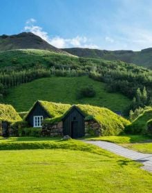 Aerial view of gold, blue and green mountainous landscape, on cover of 'Hidden Iceland', by Luster Publishing.