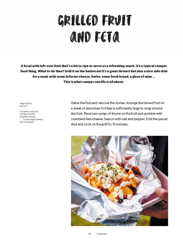 Woman sitting in doorway of campervan with black dog, in forest area, on cover of 'Camper Food & Stories', by Luster Publishing.