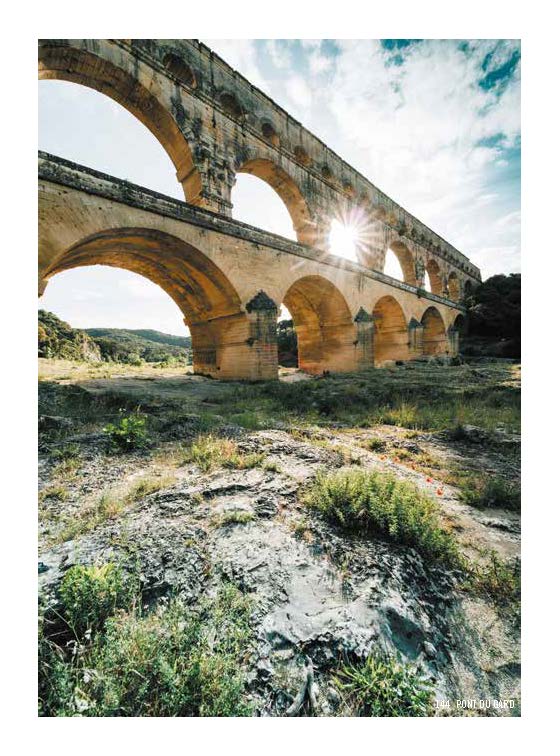 Graffitied building with cypress cloud tree, on pale yellow cover of 'The South of France for Art Lovers', by Luster Publishing.