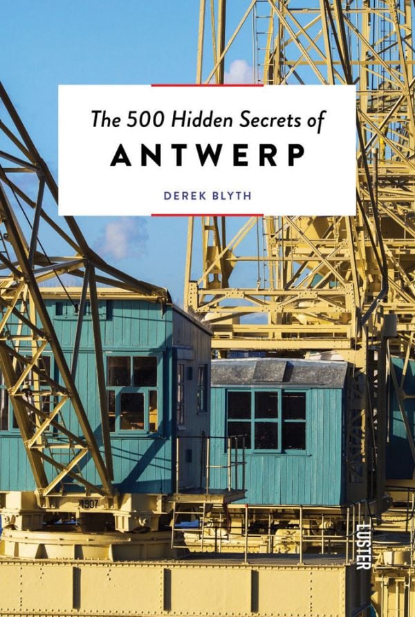 Large yellow steel structure towering over green wooden outhouses, on cover of 'The 500 Hidden Secrets of Antwerp', by Luster Publishing.