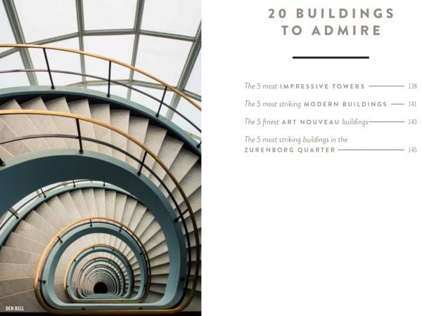 Large yellow steel structure towering over green wooden outhouses, on cover of 'The 500 Hidden Secrets of Antwerp', by Luster Publishing.