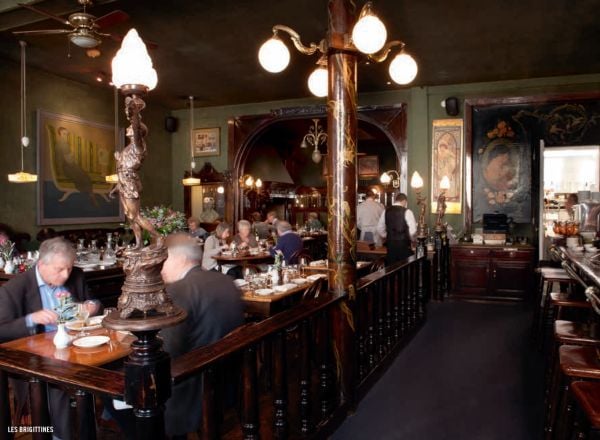 Cinema seat in a derelict theatre, looking at a white screen, on cover of 'The 500 Hidden Secrets of Brussels', by Luster Publishing.