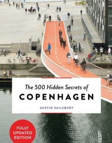 Book cover of The 500 Hidden Secrets of Copenhagenm with the Cykelslangen cyclists bridge. Published by Luster Publishing.