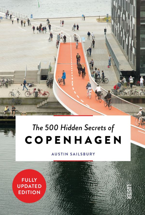 Book cover of The 500 Hidden Secrets of Copenhagenm with the Cykelslangen cyclists bridge. Published by Luster Publishing.
