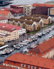 Book cover of The 500 Hidden Secrets of Copenhagenm with the Cykelslangen cyclists bridge. Published by Luster Publishing.