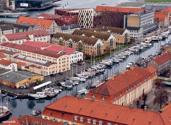 Book cover of The 500 Hidden Secrets of Copenhagenm with the Cykelslangen cyclists bridge. Published by Luster Publishing.