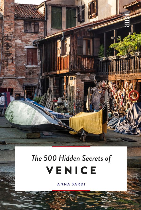 Book cover of The 500 Hidden Secrets of Venice, with a gondola workshop on canal edge. Published by Luster Publishing.