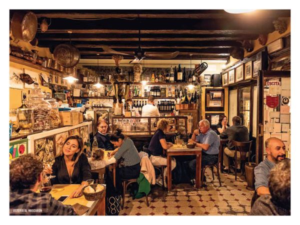 Book cover of The 500 Hidden Secrets of Venice, with a gondola workshop on canal edge. Published by Luster Publishing.