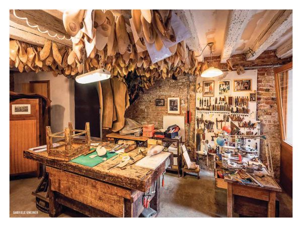 Book cover of The 500 Hidden Secrets of Venice, with a gondola workshop on canal edge. Published by Luster Publishing.