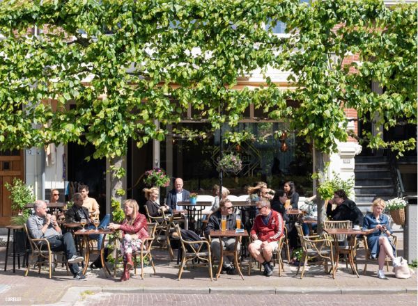 Book cover of The 500 Hidden Secrets of The Hague, with a figure walking down stairwell. Published by Luster Publishing.