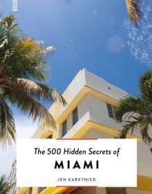 Art deco hotel with palm trees, on cover of 'The 500 Hidden Secrets of Miami', by Luster Publishing.