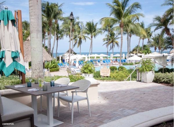 Book cover of The 500 Hidden Secrets of Miami, with Art deco hotel surrounded by palm trees. Published by Luster Publishing.