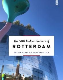 Book cover of The 500 Hidden Secrets of Rotterdam, featuring a tall sculpture in Rotterdam by artist Pipilotti Rist. Published by Luster Publishing.