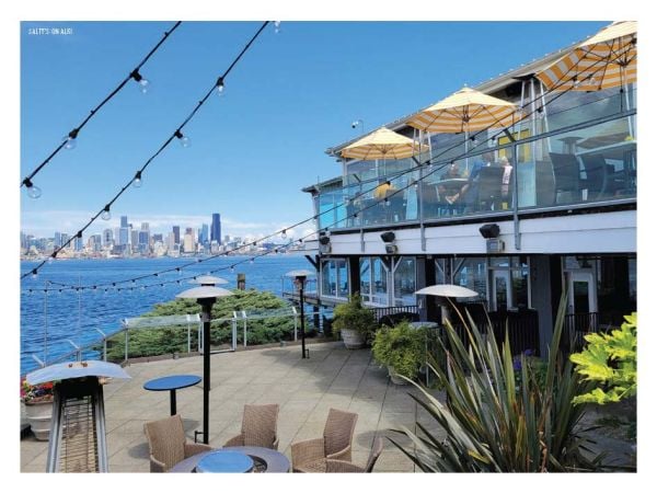 Book cover of The 500 Hidden Secrets of Seattle with the Pike Place market unlit neon sign above corrugated roof. Published by Luster Publishing.