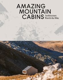 Book cover of Agata Toromanoff's Amazing Mountain Cabins: Architecture Worth the Hike, with a modern, hexagonal cabin resting on side of mountain. Published by Luster Publishing.
