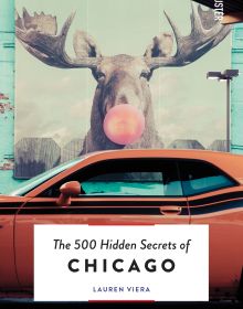Book cover of The 500 Hidden Secrets of Chicago; featuring a large mural of a moose blowing a pink bubblegum bubble, with an orange car parked in the foreground. Published by Luster Publishing.