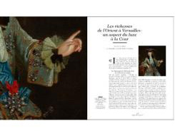 Book cover of Versailles & the World, featuring the Palace of Versailles, with ornamental gardens. Published by Exhibitions International.