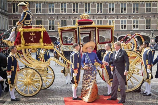 Book cover of Dress Codes: From Statement to Style Icon; featuring a model standing on a grand staircase, wearing a long, strapless dress covered in large jewels, . Published by Waanders Publishers.