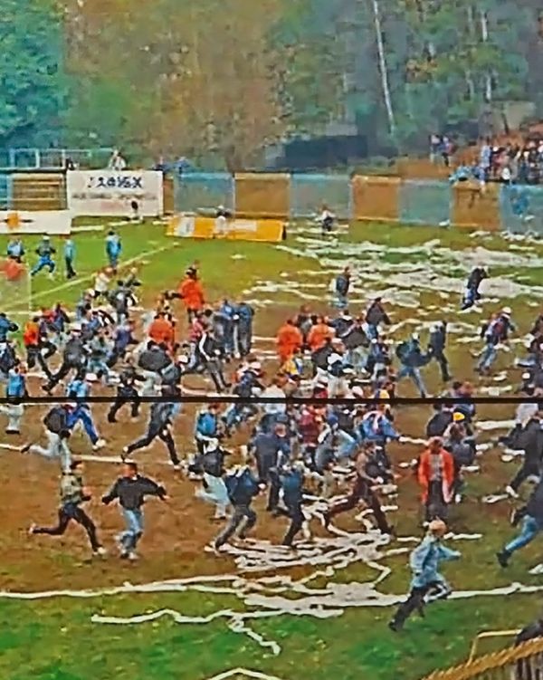 Book cover of Slash & Burn: Marcin Dudek, with a crowd of people running on a sports pitch, with paper strewn on the ground. Published by Hopper&Fuchs.