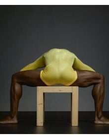 Linen book cover of Dance in Close-Up, Hans van Manen seen by Erwin Olaf, featuring the torso of male in black pants, with another person's hand on crotch area. Published by Hannibal Books.
