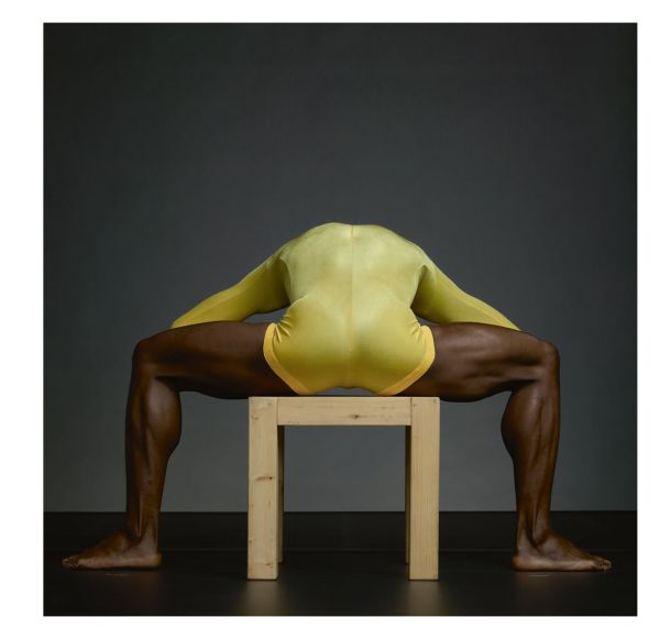 Linen book cover of Dance in Close-Up, Hans van Manen seen by Erwin Olaf, featuring the torso of male in black pants, with another person's hand on crotch area. Published by Hannibal Books.