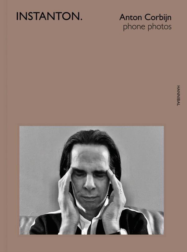 Book cover of Instanton, Phone Photos, featuring Australian singer songwriter Nick Cave, with eyes closed and fingers on temples. Published by Hannibal Books.