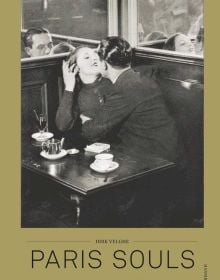 Couple gazing at one another, at French café tale, on gold cover of 'Paris Souls, Unexpected Histories of the City of Light', by Hannibal Books.