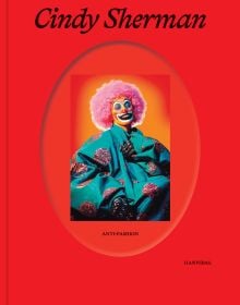 Book cover of Cindy Sherman: Anti-Fashion, with the artist dressed as a clown, wearing a pink curly wig. Published by Hannibal Books.