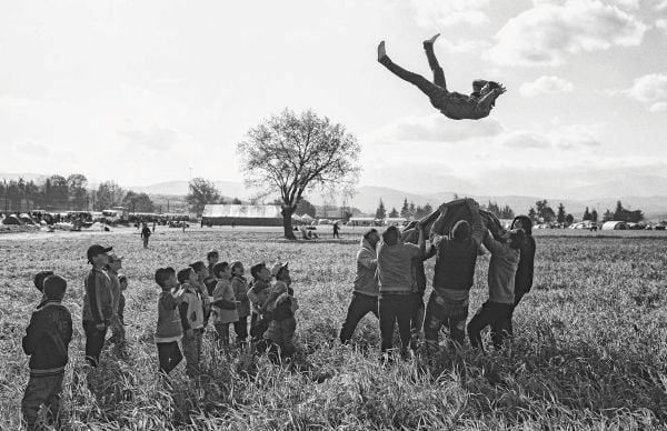 Book cover of The Family of Migrants, featuring a portrait titled 'Migrant Mother', Nipomo, California, by Dorothea Lange. Published by Silvana.