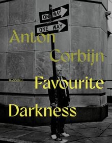Book cover of Favourite Darkness: Anton Corbijn, featuring a man standing behind a street sign. Published by Hannibal Books.