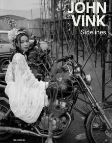 Book cover of Sidelines: John Vink, featuring a black dog and workers picking plants from water. Published by Hannibal Books.