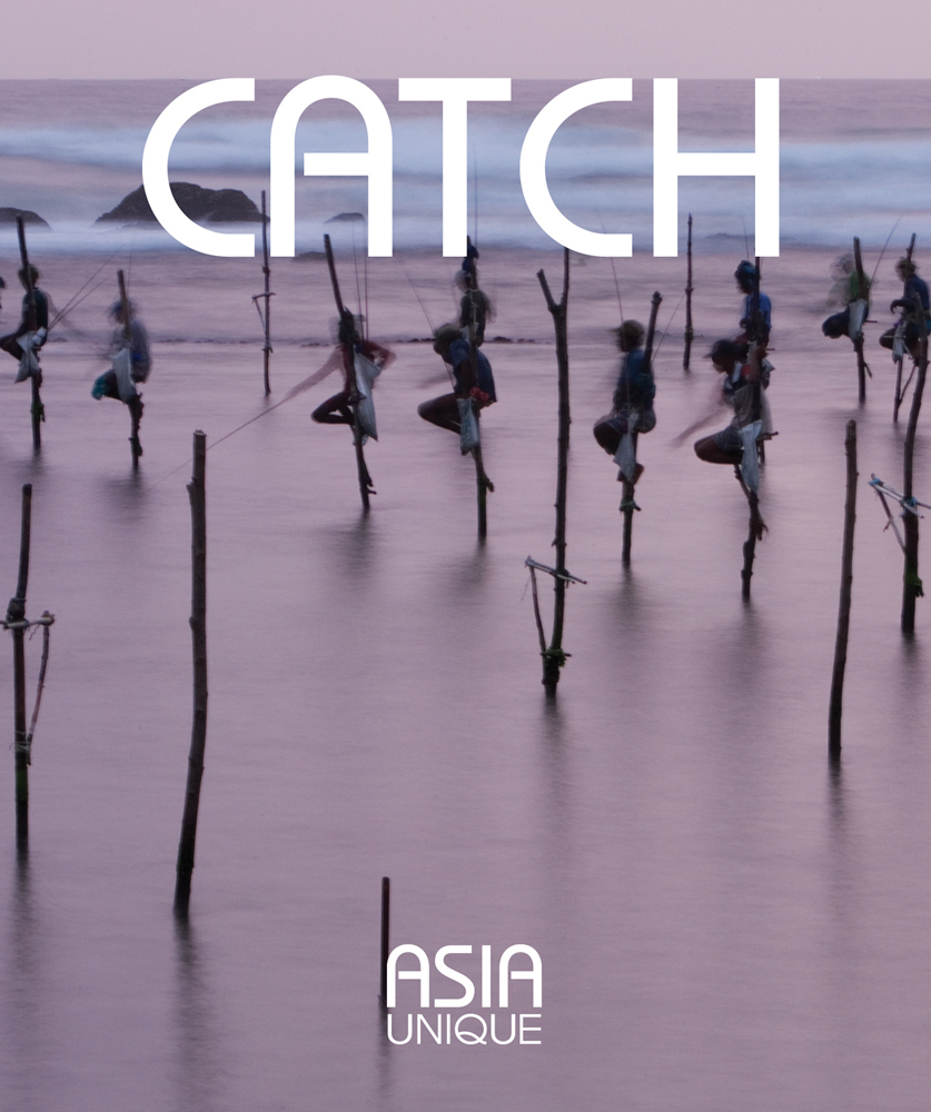Group of Asian sea fishermen on stilts, serene lilac seascape behind, CATCH ASIA UNIQUE in white font above and below.