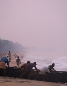 Group of Asian sea fishermen on stilts, serene lilac seascape behind, CATCH ASIA UNIQUE in white font above and below.