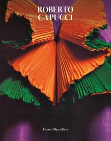 Book cover of Robert Capucci, with a shiny, pleated material in orange and green. Published by Franco Maria Ricci editore.