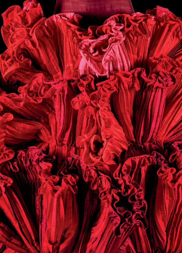 Book cover of Robert Capucci, with a shiny, pleated material in orange and green. Published by Franco Maria Ricci editore.