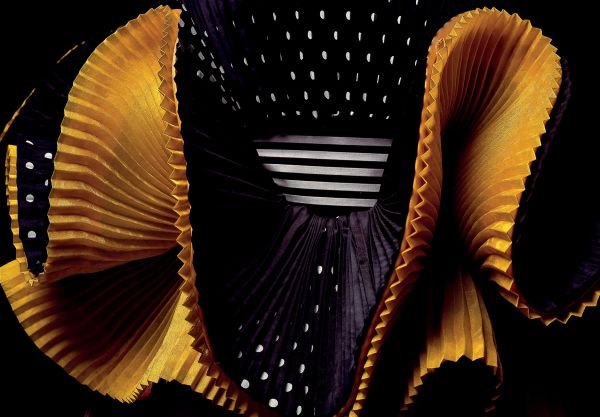 Book cover of Robert Capucci, with a shiny, pleated material in orange and green. Published by Franco Maria Ricci editore.