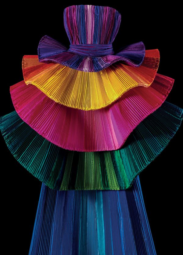 Book cover of Robert Capucci, with a shiny, pleated material in orange and green. Published by Franco Maria Ricci editore.