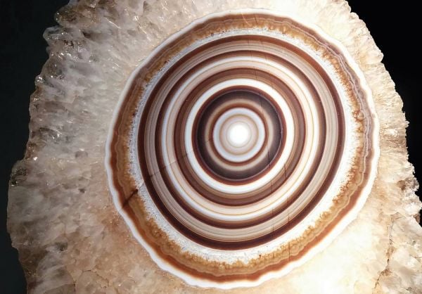 Book cover of Written in Stone: Minerals collected and described by Roger Caillois, with an orange and blue semi-precious stone. Published by Franco Maria Ricci editore.